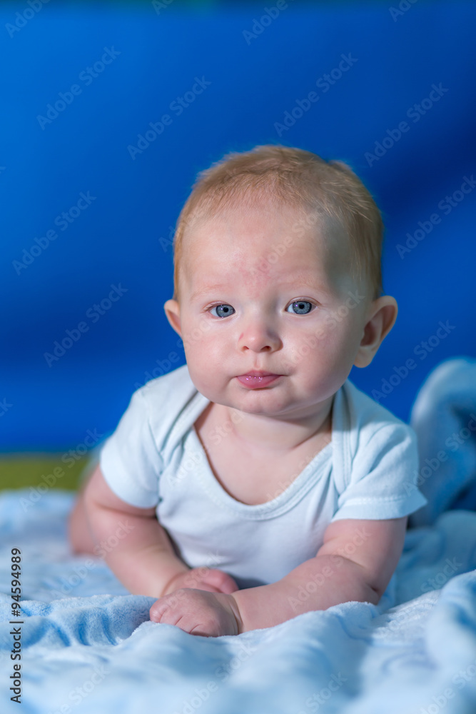 Portrait of a baby in a blue towel. Portrait of a baby in a blue towel.