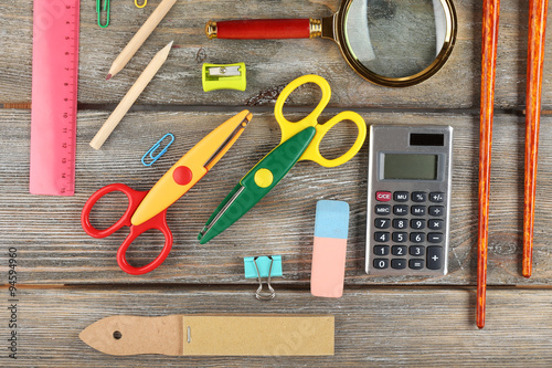 Bright stationery objects on wooden table close up © Africa Studio