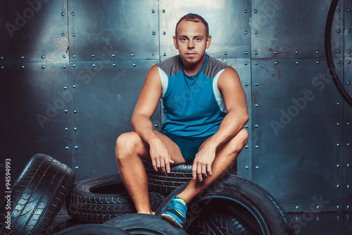 Sportsmen. fit male trainer man keeps the car tires, concept  fitness workout strenght power.
