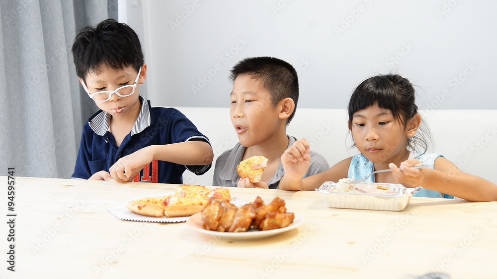 Asian children having lunch together at home. Asian children having lunch together at home.