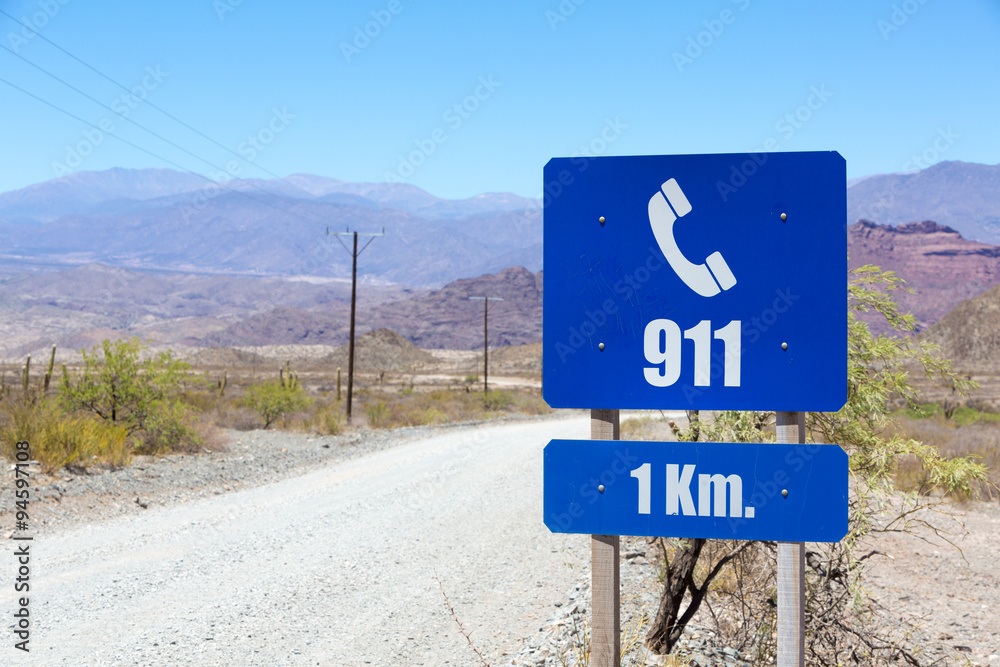 Blue help 911 sign post on Route 40 in Salta Province, Argentina Blue help 911 sign post on Route 40 in Salta Province, Argentina