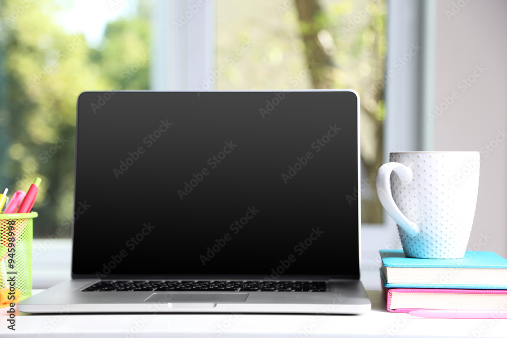 Desktop with notebook on window background Desktop with notebook on window background