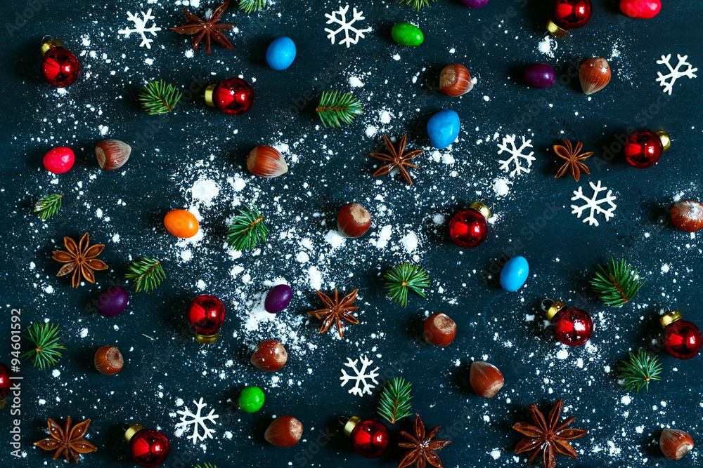Background with nuts, balls, fir-tree branches and star anise.