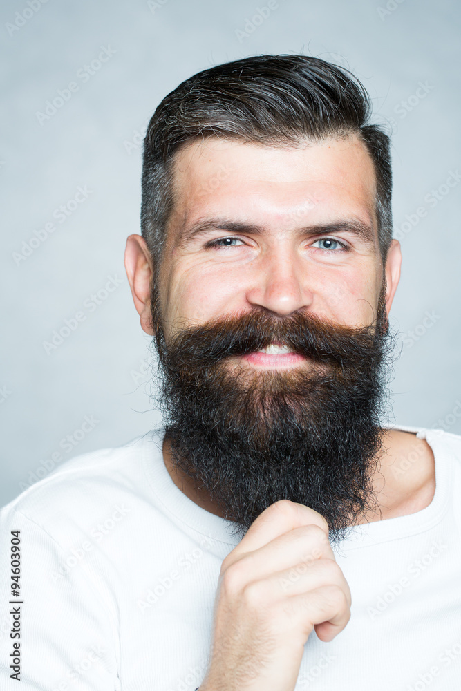 Fototapeta premium Grey-haired man pulling beard