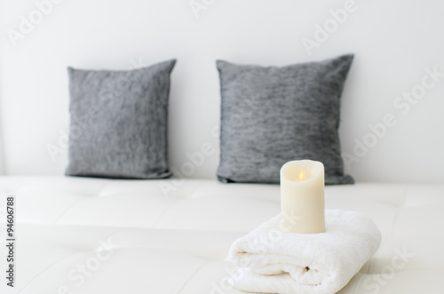 Fototapeta Naklejka Na Ścianę i Meble -  Cozy look, candle on white towel in living room.