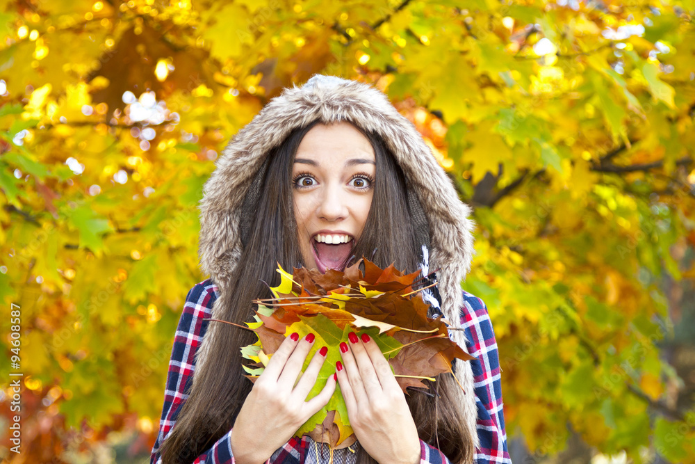 young girl with autumn leaves