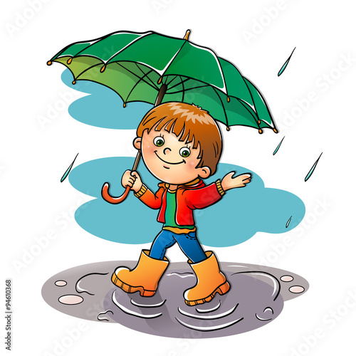 Joyful boy walking in the rain