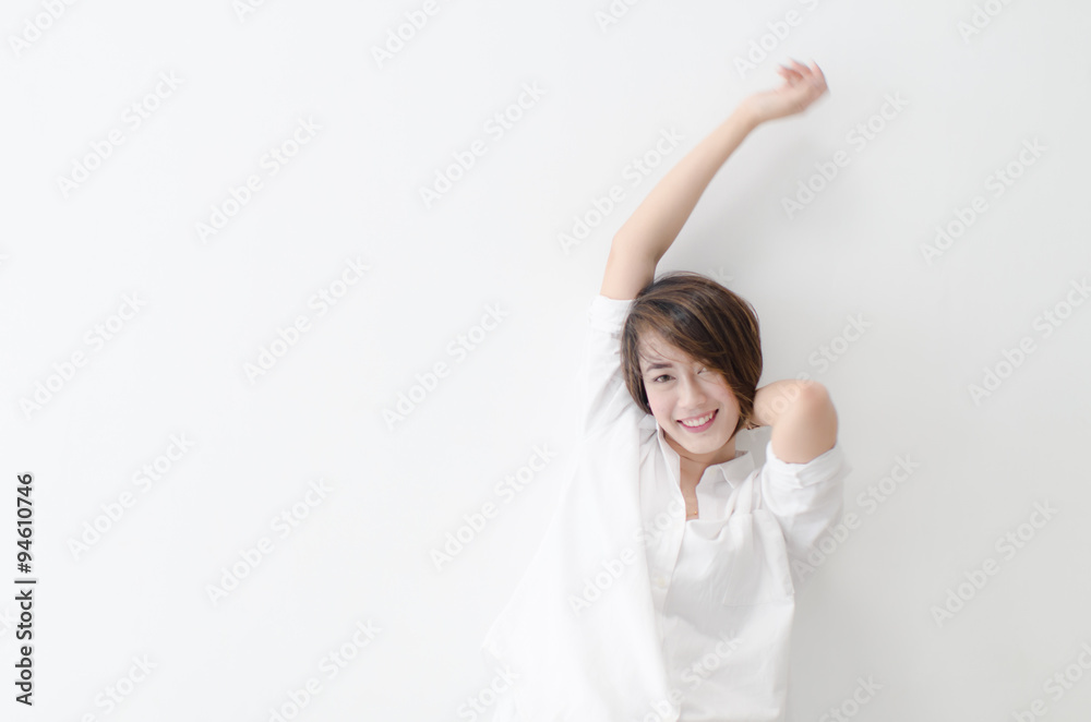 Motion blur happy Asian woman sitting on the bed, woke up and st Motion blur happy Asian woman sitting on the bed, woke up and st