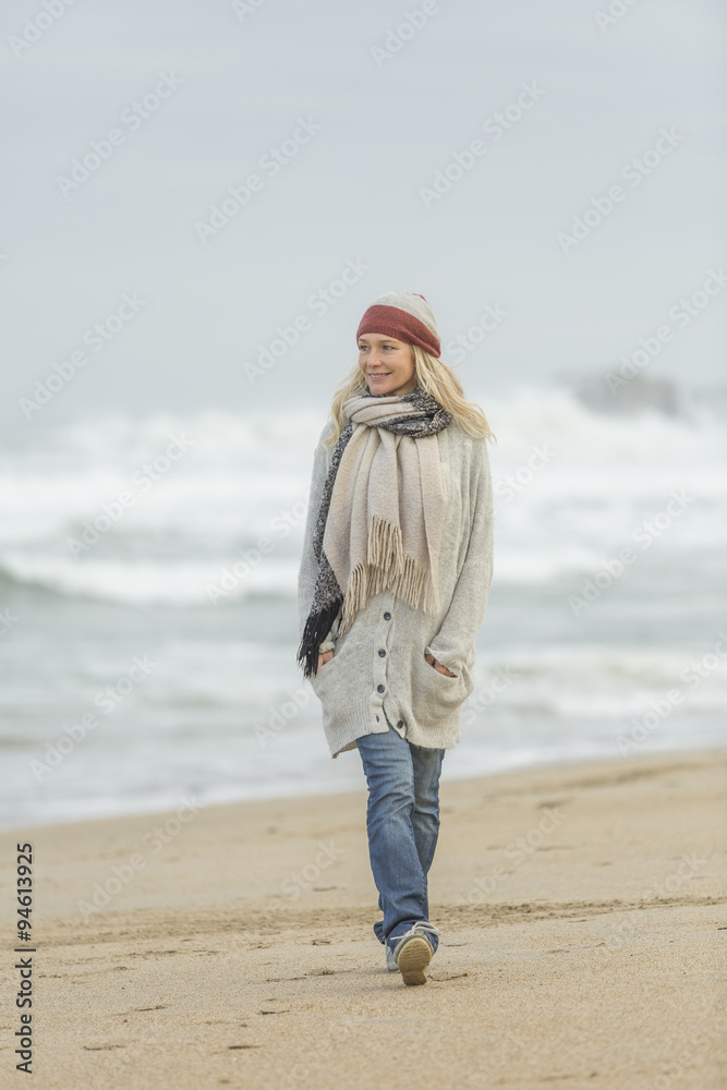 Mature woman walking on the beach