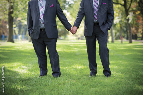 Image of two men Holding hands at gay Wedding photo