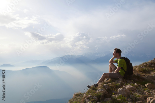 traveler enjoying panoramic view during hike, beautiful background with mountain landscape