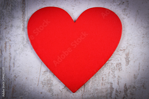 Valentine red heart on old wooden white table, symbol of love