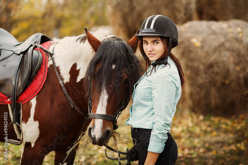 Young woman on countryside with horse for riding