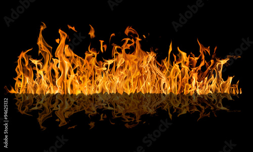 yellow fire long strip with reflection isolated on black