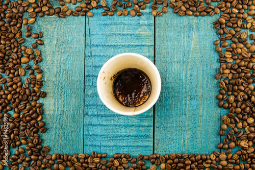 coffee Cup and beans on a blue wooden background