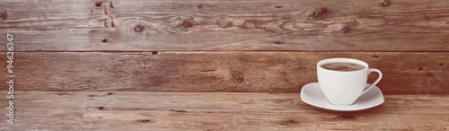 cup of coffee on wooden background