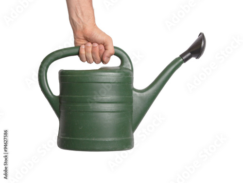 Hand holding green watering can