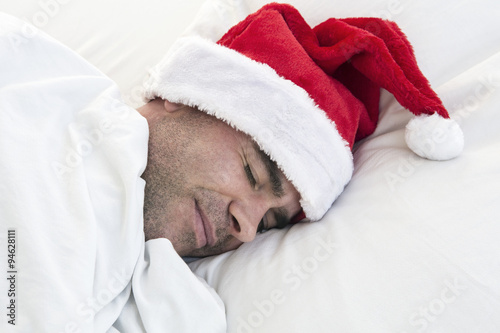 man sleeping with santa hat © wernerimages