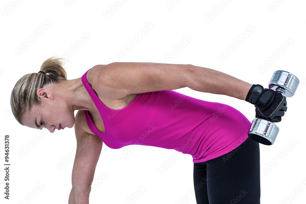 Muscular woman exercising with dumbbells 