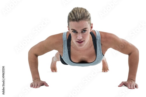 Muscular woman doing push-ups