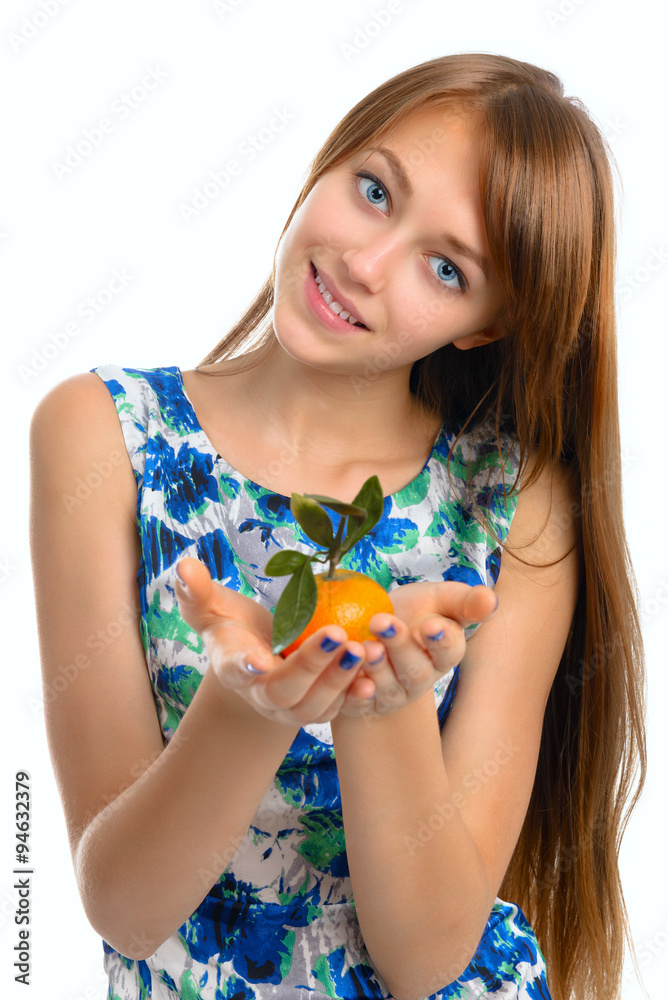 Portrait of a beautiful young smiling girl with a tangerine. Portrait of a beautiful young smiling girl with a tangerine.