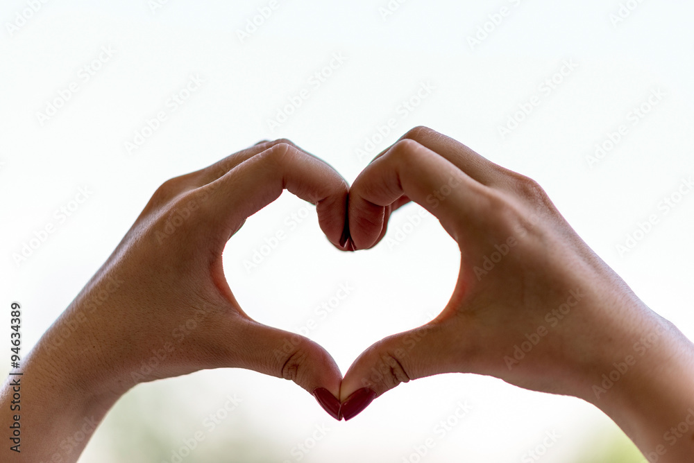 Two female hands shaping a heart, close up Two female hands shaping a heart, close up