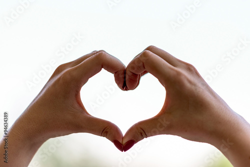 Two female hands shaping a heart  close up