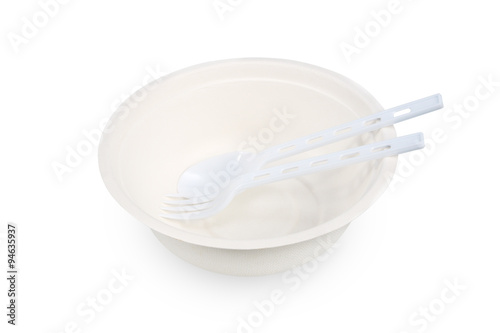 Paper food container with plastic spoon and fork on white backgr