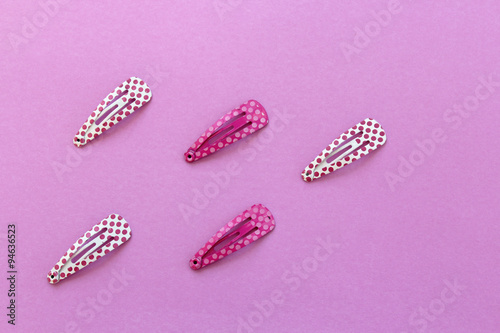 Hair clips on pink background