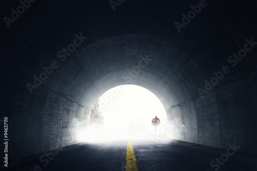 old grunge stop sign in fog and darken tunnel with fog and light