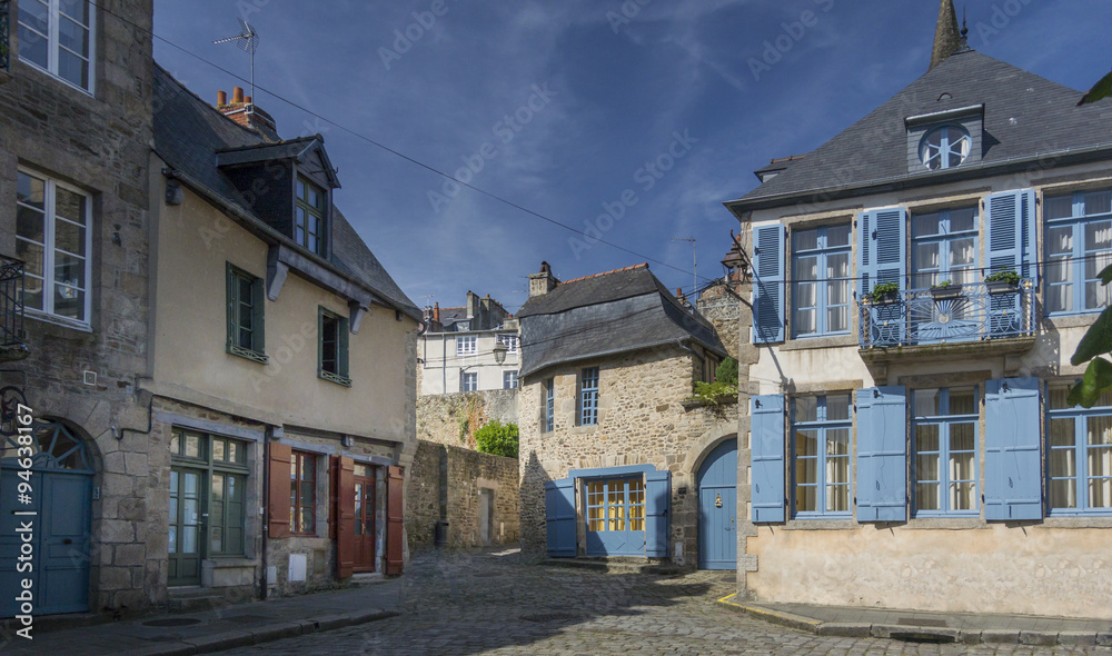 Medieval cobbled street and buildings in the city of Dinan, Brittany, France