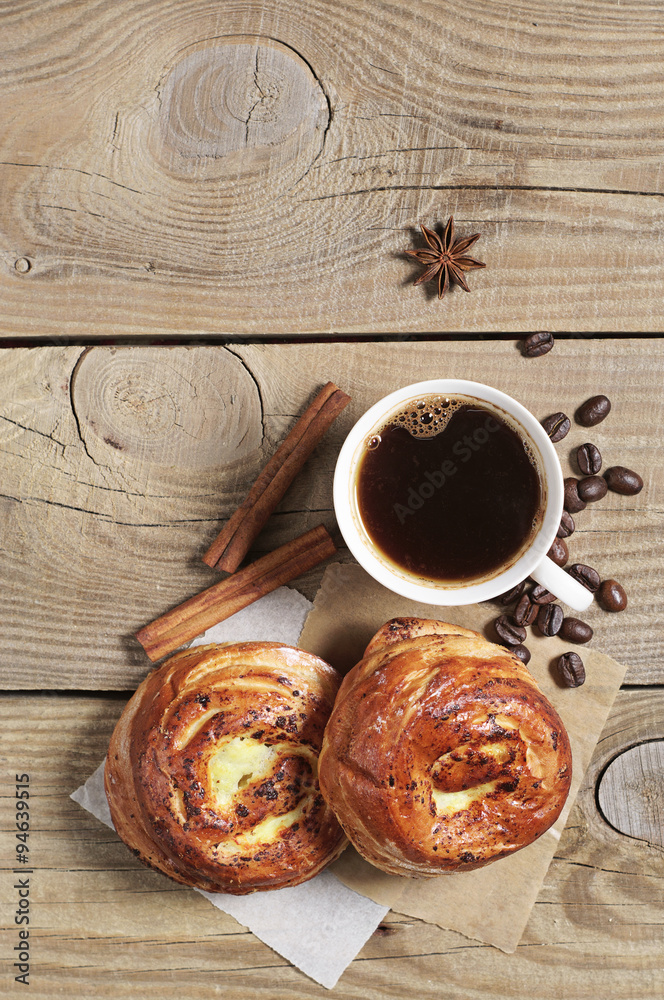 Two buns with jam and cup of coffee