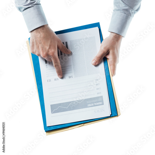 Business man checking a financial report