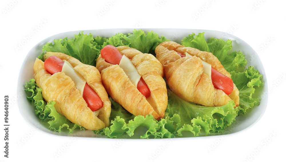 Croissant with sausage and lettuce isolated on white background