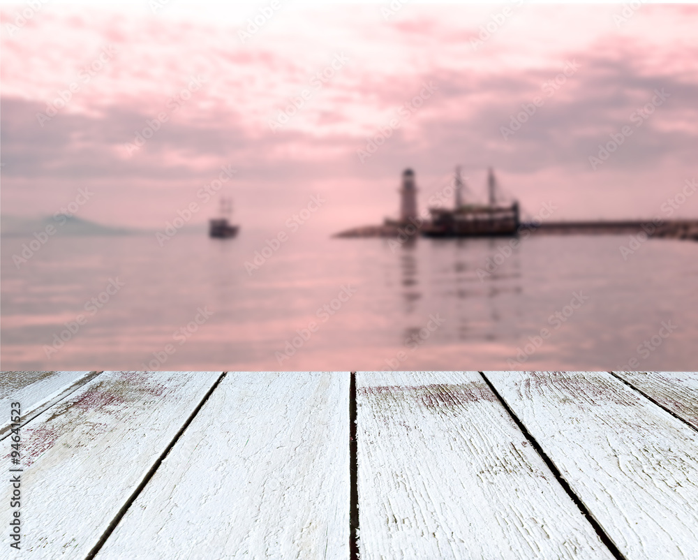 Lighthouse and ships, the sea, sunset, wooden plank in perspective