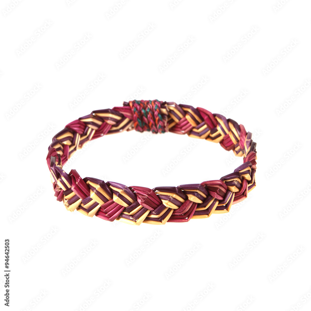 wristband made from woven straw on a white background.