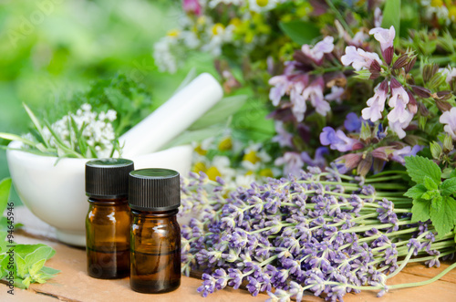 essential oils with herbal flowers for aromatherapy treatment