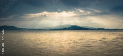 Grandiose panorama of Lake in Switzerland. In the background is a mountain landscape  sun rays play light and shadow.