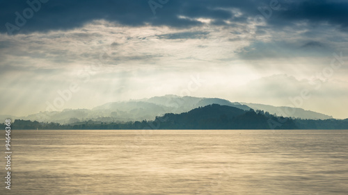 Grandiose panorama of Lake in Switzerland. Sun rays play light and shadow.