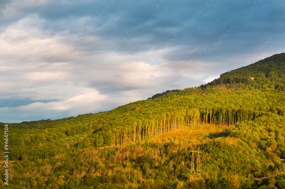 Fototapeta premium Deforestation in the mountains with dark clouds