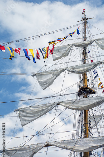 The mast of the ship with flags