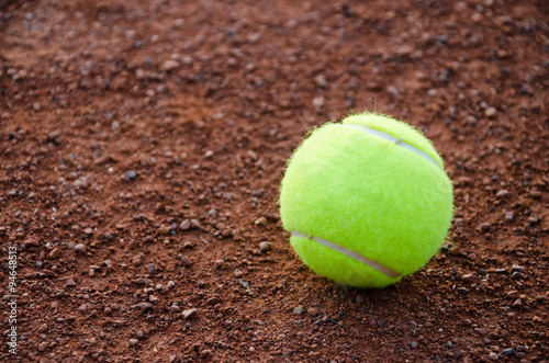 Yellow ball for tennis on ground court cover. Selective focus. For background, backdrop, catalog print, web use with space for a text.
