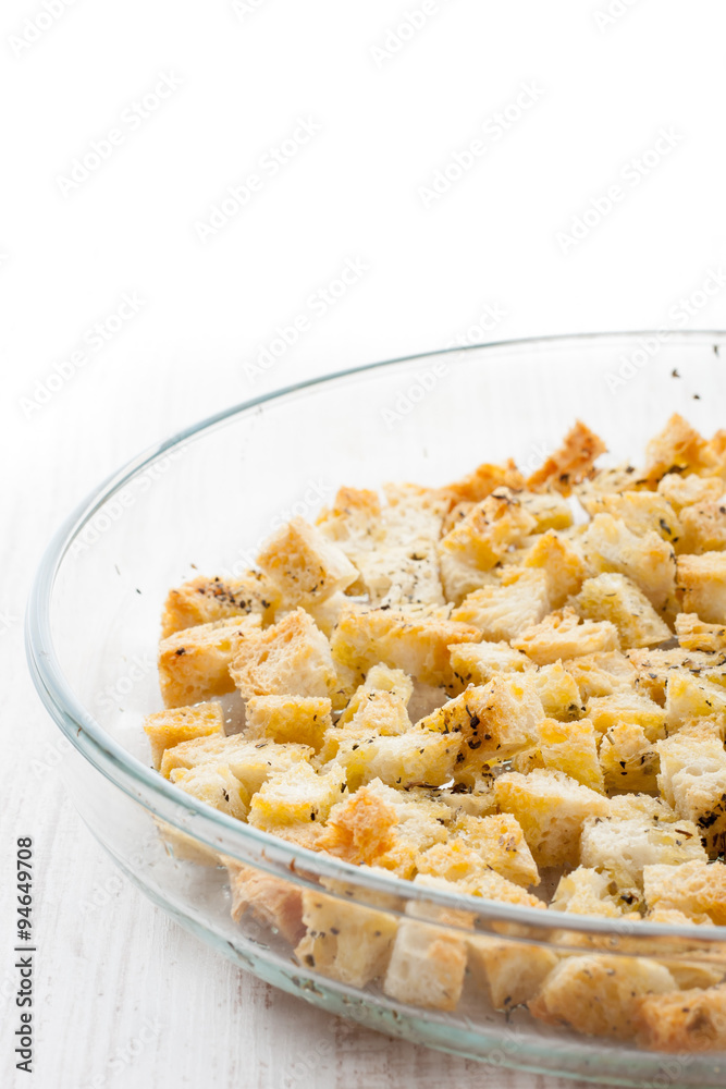 Small croutons with pepper on the glass dish at the right of the table Small croutons with pepper on the glass dish at the right of the table