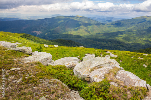 landscape with white sharp boulders on the hillside near mountain peak © Pellinni