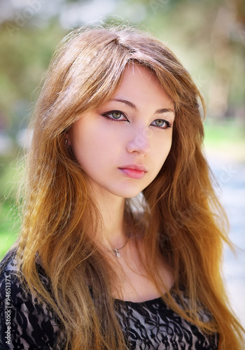 Portrait of beautiful young girl at park. Beautiful girl portrai © es0lex