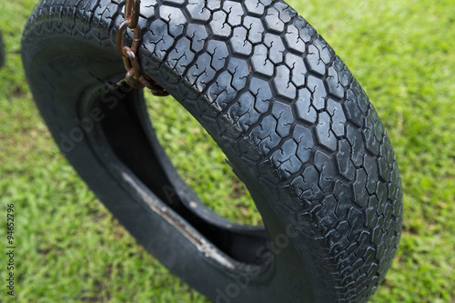 Expired tire use for tire swing hanging in a park, Thailand