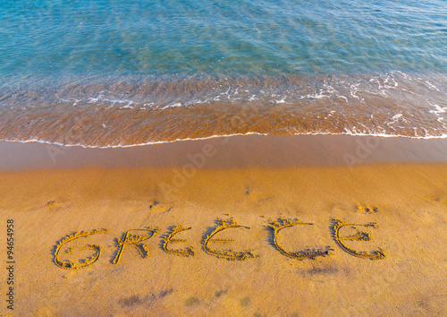 the name of GREECE written on the sand of Kardamaina beach at Kos island in Greece photo