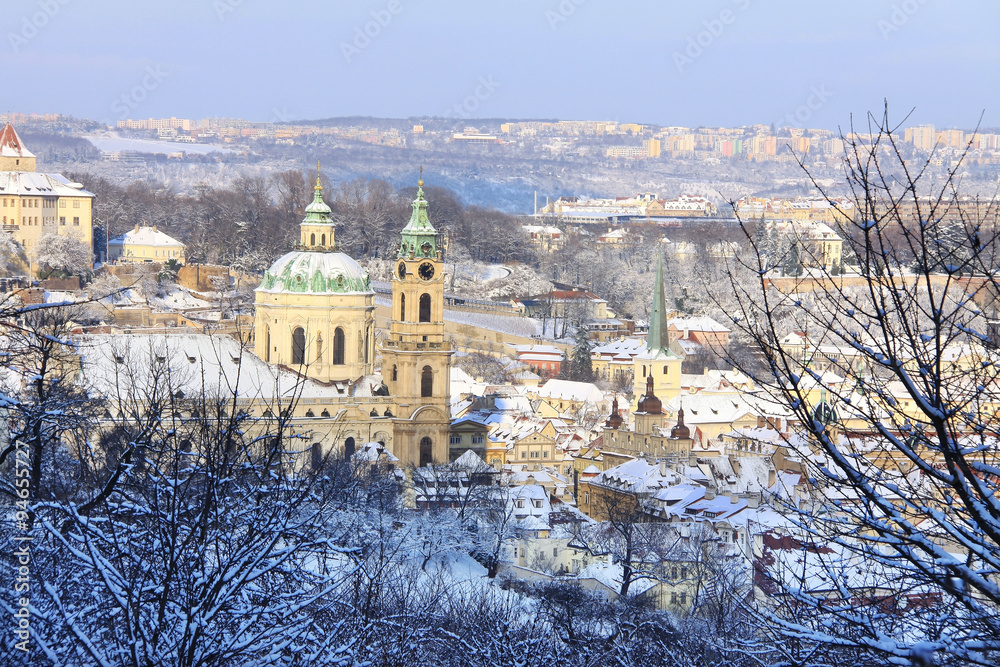 Obraz premium Romantic snowy Christmas Prague City with St. Nicholas' Cathedral, Czech Republic