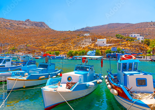 traditional fishing boats docked at the port of Vathi village in Kalymnos island in Greece