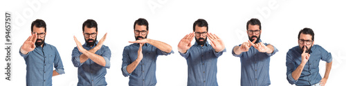 Young hipster man doing NO gesture